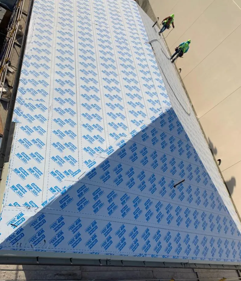 Professional roofers installing underlayment on a metal roof in Brigantine